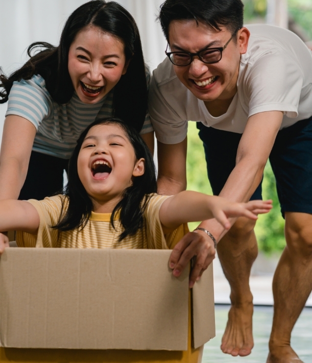 Smiling family enjoying playtime, promoting family counselling in Singapore.
