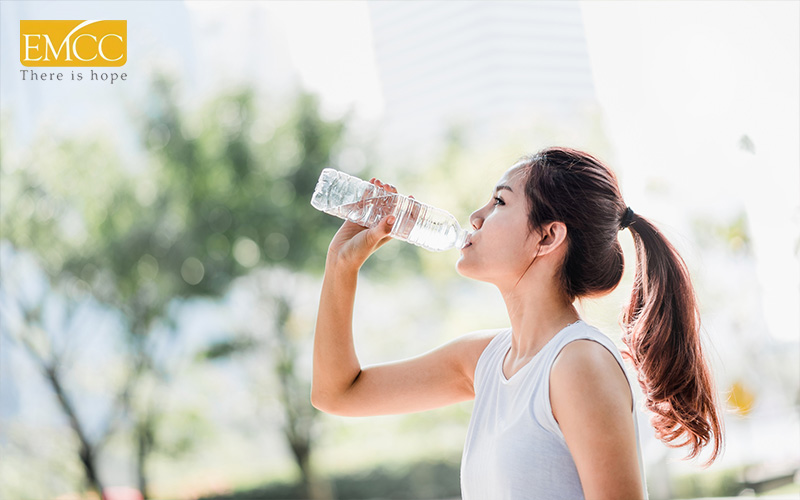 Woman drinking water after a run