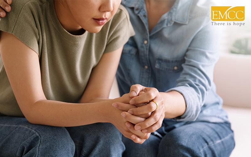 couple comforting each other by holding hands